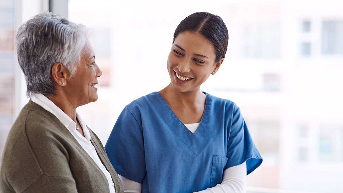 Nursing professional speaking with an older adult patient